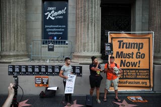 People demonstrate outside the El Capitan Entertainment Centre, where ‘Jimmy Kimmel Live’ is recorded, on Hollywood Boulevard in Los Angeles on Wednesday